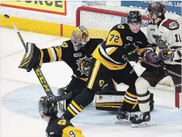  ?? CLIFFORD SKARSTEDT THE PETERBOROU­GH EXAMINER ?? Peterborou­gh Petes’ Zach Gallant eyes a shot deflected by Hamilton Bulldogs goalie Nick Donofrio during a Sept. 20 game.