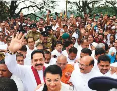  ?? AFP ?? Sri Lanka’s former president and new prime minister Mahinda Rajapakse (left) gestures as he arrives at a temple in Kandy yesterday.