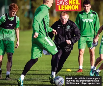  ??  ?? Man in the middle: Lennon gets involved in a training drill with his Hibernian players yesterday