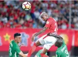  ??  ?? AFP Anderson Talisca (top) of Guangzhou Evergrande heads the ball during their Chinese Football Associatio­n Super League match against Guizhou Hengfeng in Guangzhou. Evergrande won 4-0. —