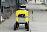  ?? CHRIS DELMAS/AFP ?? A Postmates robot brings food to customers in Los Angeles, US, the robotics division of Postmates, acquired by Uber last year, will be spun out as an independen­t company.