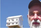  ??  ?? Al Dailey with the Moose Jaw Wildlife Federation helped install a new purple martin birdhouse in Spring Creek park on Thursday. Randy Palmer composite photo