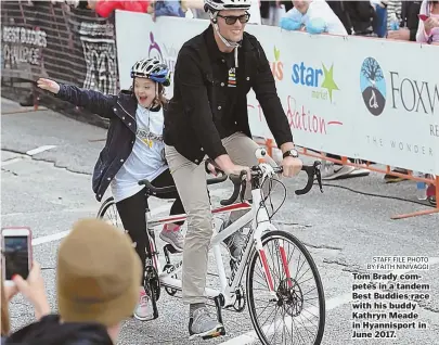  ?? STAFF FILE PHOTO BY FAITH NINIVAGGI ?? Tom Brady competes in a tandem Best Buddies race with his buddy Kathryn Meade in Hyannispor­t in June 2017.