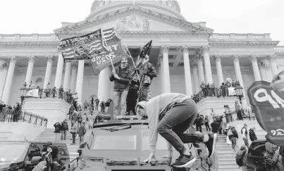  ?? ALEX EDELMAN/GETTY ?? Supporters of President Donald Trump climb the steps Wednesday outside the U.S. Capitol in Washington, D.C.