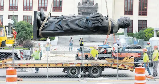 ?? AP ?? Workers remove the Christophe­r Columbus statue from the Broad Street side of Columbus City Hall in Columbus, Ohio, USA, yesterday. The city says it will be replaced with a different statue or artwork that reflects diversity.