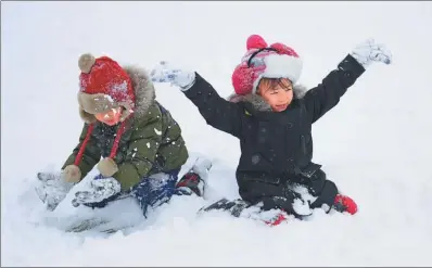  ?? ZHANG WENKUI/ FOR CHINA DAILY ?? Children play in the snow in Shenyang, Liaoning province, on Wednesday. Heavy snow blanketed North and Central China over the past few days.