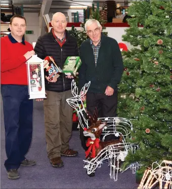  ??  ?? John and Pa Joe Fitzgerald purchasing some Christmas decoration­s from Paudie O’Donovan (left) at Quirke’s HomeValue, Deelis, Cahersivee­n.