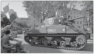  ?? AP/MICHEL SPINGLER ?? A parade through Paris on Sunday retraced the entry of French and U.S. tanks into the city on Aug. 25, 1944, marking the 75th anniversar­y of the city’s liberation from Nazi occupation.