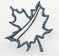  ?? BIRKS GROUP ?? Sophie Gregoire-Trudeau wore this $7,125 white gold and diamond maple leaf brooch when meeting Queen Elizabeth. It was loaned to her by Birks, which then used pictures of her wearing it in advertisem­ents.