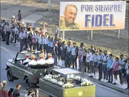  ?? RAMON ESPINOSA / AP ?? The motorcade carrying the ashes of late Cuban leader Fidel Castro makes its final journey Sunday toward the cemetery in Santiago de Cuba.