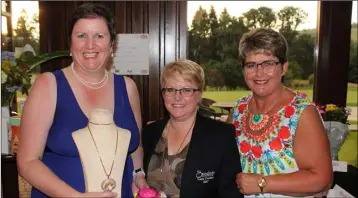  ??  ?? Margaret Moore receiving her first prize from lady Captain Siobhán Moore and Vice-Captain Joanne Kenny as winner of the Bunclody Golf and Fishing Club lady Captain’s day held on July 2.