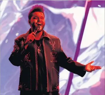  ?? Kevin Winter Getty Images ?? THE WEEKND shares 1980s pop ’n’ soul sounds and textures with Bruno Mars, but his content is darker.