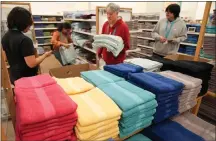  ?? SETH WENIG — THE ASSOCIATED PRESS ?? Employees arrange a display at a Kohl’s store in Clifton, N.J., on Jan. 26. On Thursday, the Commerce Department said retail sales rose in February.