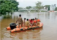  ?? —Reuters ?? Rescue personnel patrol the flooded waters after the opening of Idamalayar and Cheruthoni dam shutters on Friday.