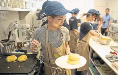  ?? LUCAS OLENIUK/TORONTO STAR ?? Yuka Naka runs the griddle at Fuwa Fuwa Japanese pancakes in the Annex. The restaurant’s name means “fluffy fluffy.”