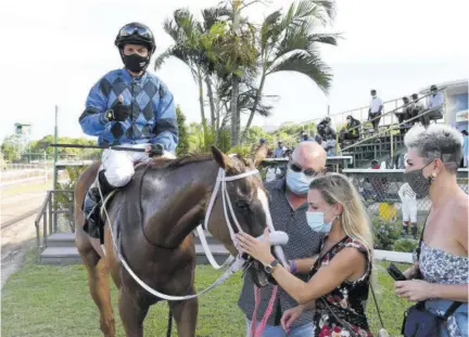  ?? (Photo: Joseph Wellington) ?? Visitors from Switzerlan­d Viviana Adermatt (touching Hoist The Mast - second right) and entertaine­r Lady Wolf (right) join trainer Anthony Nunes (third right) and jockey Dick Cardenas in the winners’ enclosure.
