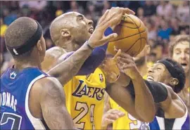  ?? Julie Jacobson Associated Press ?? IN A SCRAMBLE, Kobe Bryant, who finished with 22 points in 28 minutes, is fouled by Sacramento’s James Johnson, right, as Isaiah Thomas, left, closes in.