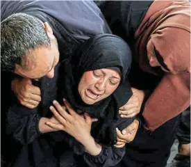  ?? /Reuters ?? Death toll: A woman reacts next to the bodies of Palestinia­ns (not pictured) killed in Israeli strikes in Rafah, in the southern Gaza Strip, on Tuesday.