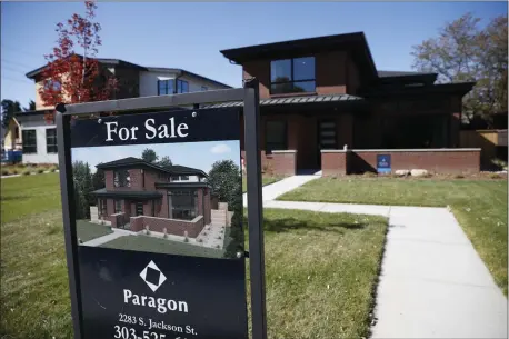  ?? [AP PHOTO] ?? A sign stands outside a new home for sale in southeast Denver.