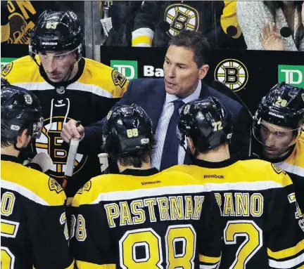  ?? ELISE AMENDOLA/AP PHOTO ?? Bruce Cassidy, centre, returned to his hometown to face the Senators Monday with his Bruins firmly in playoff contention.