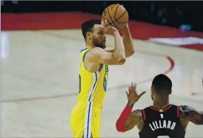  ?? CRAIG MITCHELLDY­ER — THE ASSOCIATED PRESS ?? Golden State Warriors guard Stephen Curry, left, shoots over Portland Trail Blazers guard Damian Lillard during the first half Wednesday in Portland, Ore.