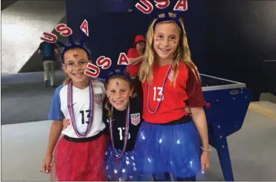  ?? Photo by Liz Clarke / The Washington Post ?? Charlotte Nims, 9; Amelia Nims, 8; and Audrey Nims, 12, sisters from Austin, Texas, are shown prior to kickoff at Parc des Princes in Paris, France.