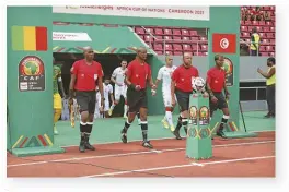  ?? ?? Referee Janny Sakizwe (2nd from left) leads match officials onto the field ahead of the AFCON match between Tunisia and Mali.