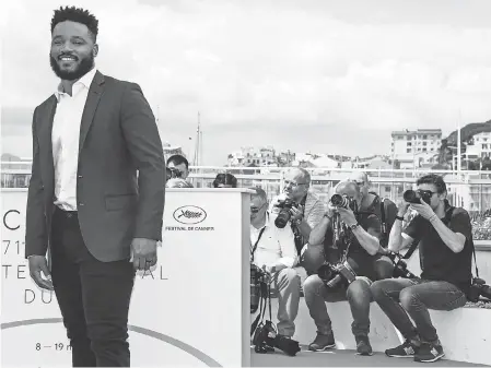  ?? CLEMENS BILAN/EPA-EFE ?? Director Ryan Coogler doesn’t need to have a film at Cannes to be a star. While he was there, he spilled some “Black Panther” secrets.