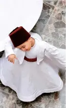  ??  ?? Three-year-old Sufi dervish dancer Anas al-Kharrat dances at his home in the old city of Damascus, Syria. — AFP