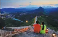  ?? PHOTOS PROVIDED TO CHINA DAILY ?? Left: Visitors enjoy the sunset on the Great Wall. Center: Zhou Wenjun (left), a security guard at the Simatai section of the Great Wall, shares his knowledge about the site with visitors. Wall features delicate carvings of Qilin, a Chinese mythical creature.