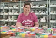  ?? DAVID J. PHILLIP - THE ASSOCIATED PRESS ?? Elizabeth Butts, owner of Sprinkle Pop, a company based in Houston that makes upscale sprinkles for bakers, poses for a photo inside her business in Houston. Butts is building out and equipping a 10,000-square-foot facility for storage and shipping. She’s reinvestin­g the company’s profits rather than seeking investors, which will make it easier for her to run the company, but she also doesn’t want to burden her company with debt.