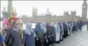  ?? REUTERS ?? Participan­ts in the Women's March organised after Donald Trump’s inaugurati­on gathered on Westminste­r Bridge on Sunday to hold hands in silence to remember victims of the London attack.