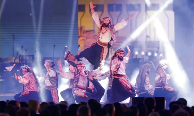  ?? —AFP photos ?? Dancers perform on stage during the opening ceremony of the Damascus Internatio­nal Fair on August 17. The fair is an annual event which returned to the capital after a hiatus of six years.