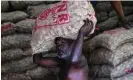  ?? Photograph: AFP/Getty Images ?? A labourer carries a sack of onions at a market in Colombo. The IMF has approved a $2.9bn bailout for the island nation.