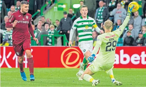  ?? Pictures: SNS. ?? Cluj’s George Tucudean scores to make it 4-3 and knock Celtic out of the Champions League.