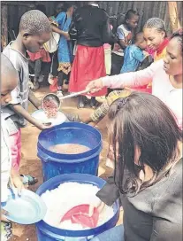  ?? SUBMITTED PHOTO ?? Stacey Baldwin helps serve rice and beans at a local primary school in Kibera. She was told that for some children, this is their lone meal of the day.