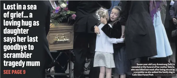  ?? MARK MARLOW/PACEMAKER ?? Seven-year-old Lucy Armstrong (left) is consoled at the funeral of her mother Valerie, who was killed last week after being struck by
a scrambler as she walked the family dog in Colin Glen Forest Park