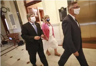  ?? NICOLAUS CZARNECKI / HERALD STAFF FILE ?? SENATE BRAIN TRUST: State legislativ­e leaders Sen. Bruce Tarr, left, Senate President Karen Spilka, center and Sen. Michael Rodrigues walk the halls of the State House earlier this year.