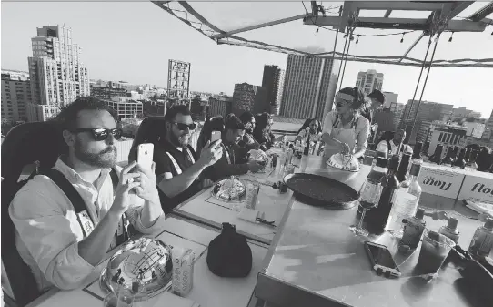  ?? DAVID KAWAI ?? Media participat­ed in an early preview of the Ottawa 2017 Sky Lounge experience on Thursday. Until July 22, diners can be hoisted high in the sky outside city hall.