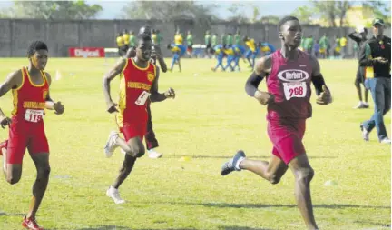  ??  ?? Herbert Morrison’s Trevoy Smith (right) wins the Class 3 boys’ 400m at last year’s COCAA Western Champs held at the STETHS Sports Complex in Santa Cruz. At left is Cornwall College’s Zachary Cox, who was second.