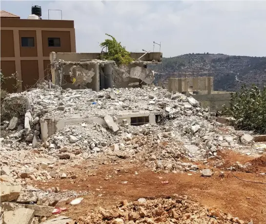  ??  ?? THE ATTA FAMILY home in Deir Abu Meshaal, post-demolition.