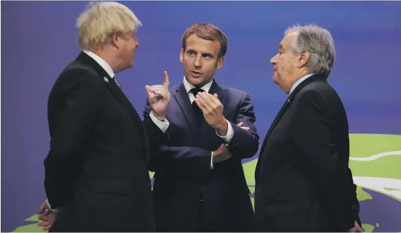  ?? Reuters ?? British Prime Minister Boris Johnson, French President Emmanuel Macron, centre, and UN Secretary General Antonio Guterres talk at the Cop26 UN climate change conference in Glasgow, Scotland, yesterday. Mr Johnson invoked the spirit of British superspy James Bond, saying the world faced a ‘doomsday device’