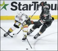  ?? Craig Lassig The Associated Press ?? Knights left wing Erik Haula (56) and Wild left wing Jordan Greenway battle for the puck in the third period Saturday in St. Paul, Minn. The Knights beat the Wild 2-1 in a shootout.