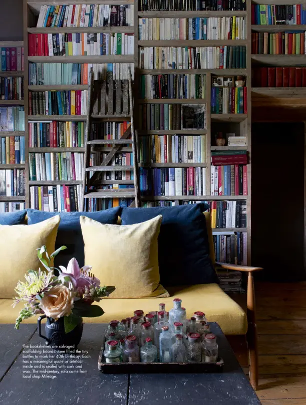  ??  ?? The bookshelve­s are salvaged scaffoldin­g boards. Jane filled the tiny bottles to mark her 40th birthday. Each has a meaningful quote or artefact inside and is sealed with cork and wax. The mid-century sofa came from local shop Mileage.
March 2021