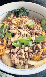  ?? GRETCHEN MCKAY/PITTSBURGH POST-GAZETTE TNS ?? Made with a spicy sauce containing Sichuan chili oil and garlic, and topped with crispy round pork, Dan Dan Noodles are a popular street food in China.