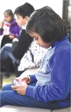  ??  ?? An Indian girl uses a smartphone to study with an app created by Planet Sparks that uses ‘gamified' teaching methods at a tuition centre in New Delhi. — AFP photo