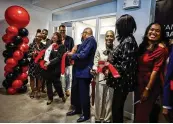  ?? ?? Representa­tives of the Miami Valley Urban League, community leaders and stakeholde­rs cut the ribbon on the organizati­on’s new offices at the Dayton Arcade Monday afternoon.