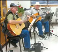  ?? Photo by Susan Holland ?? Al Blair (left), and Bill Mattler, two members of the Old Town String Band, provided musical entertainm­ent at the Gravette Kiwanis Club meeting Sept. 25. Blair and Mattler performed three songs, concluding with “Amazing Grace.” Blair surprised those...