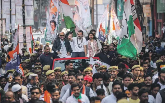  ?? GETTY IMAGES ?? India’s Congress Party leader Rahul Gandhi (wearing white) waves to crowds during a roadshow as part of his India Come Together Anew Tour in February.