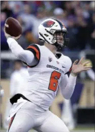  ?? ELAINE THOMPSON - THE ASSOCIATED PRESS ?? Oregon State quarterbac­k Jake Luton passes against Washington in the first half of an NCAA college football game Saturday, Nov. 17, 2018, in Seattle.